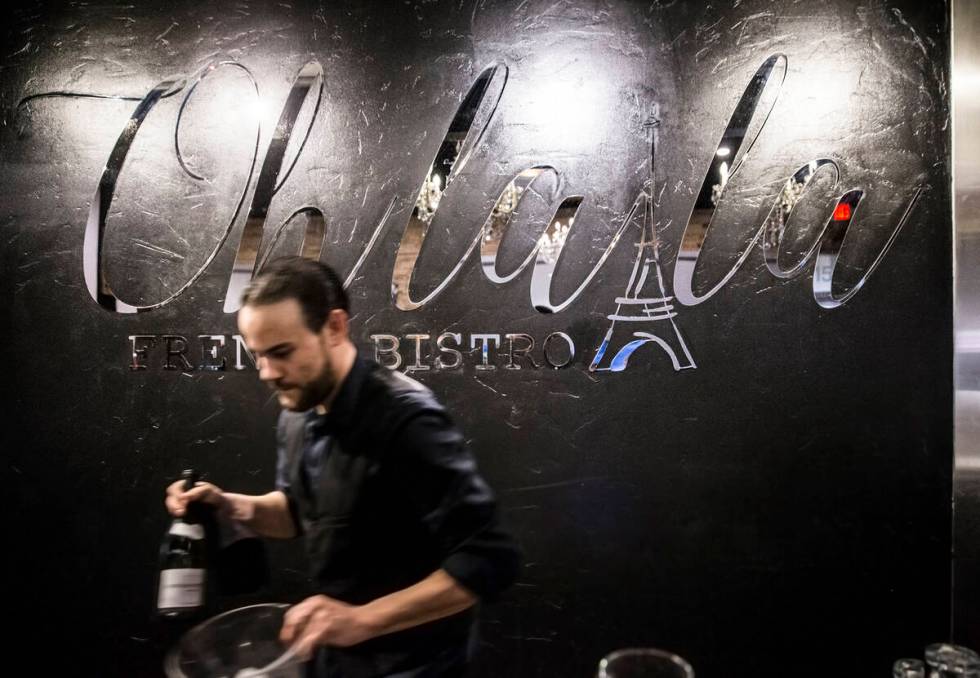 Manager Anthony DiSalvo prepares wine for a table at Ohlala French Bistro on Wednesday, March 1 ...