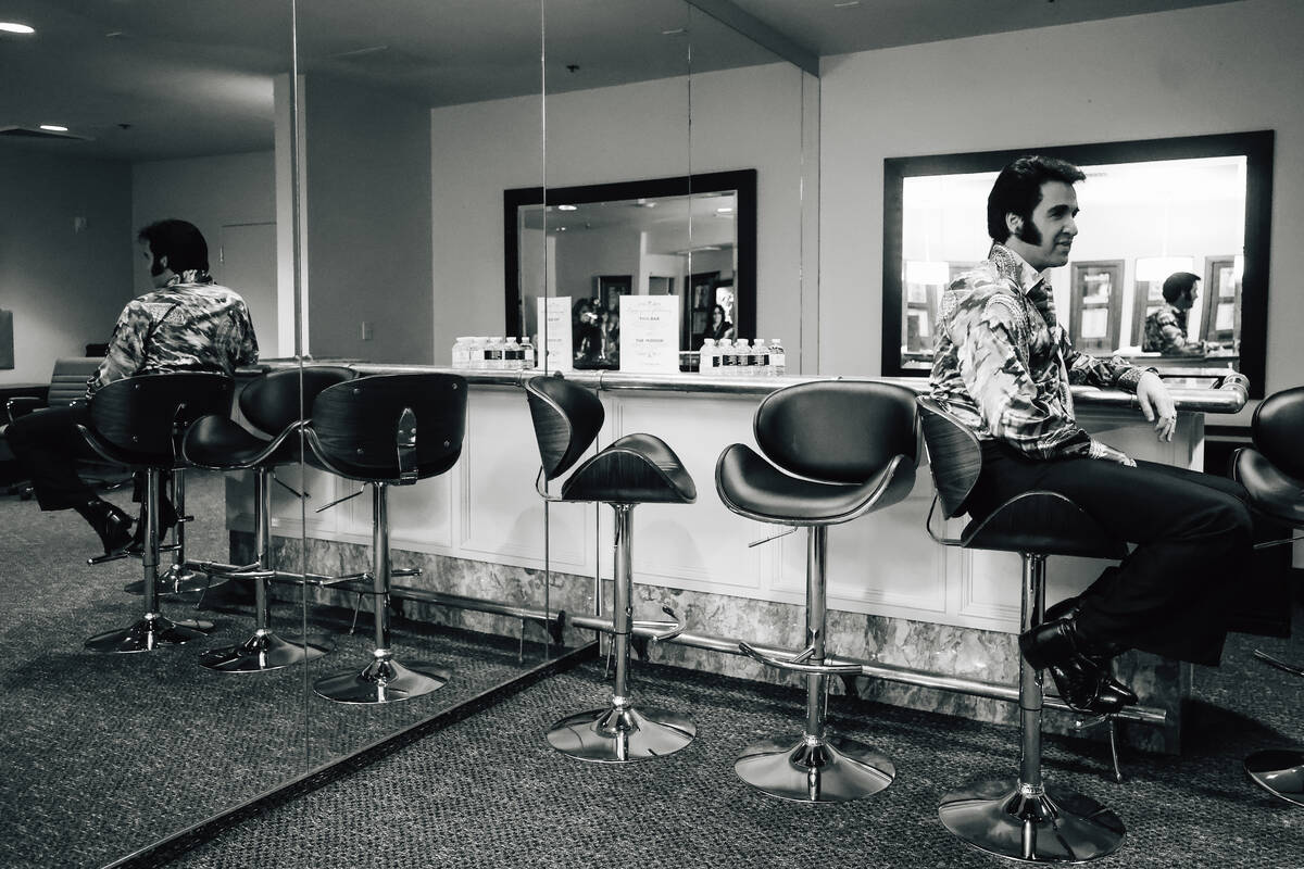 Travis Powell, an Elvis tribute artist, sits at the bar in his green room during “1969 L ...