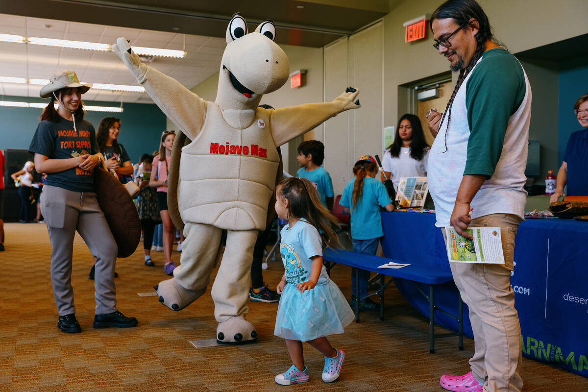 Mojave Max dances with a child during Discovery Day on Saturday, June 28, 2025 at Clark County ...