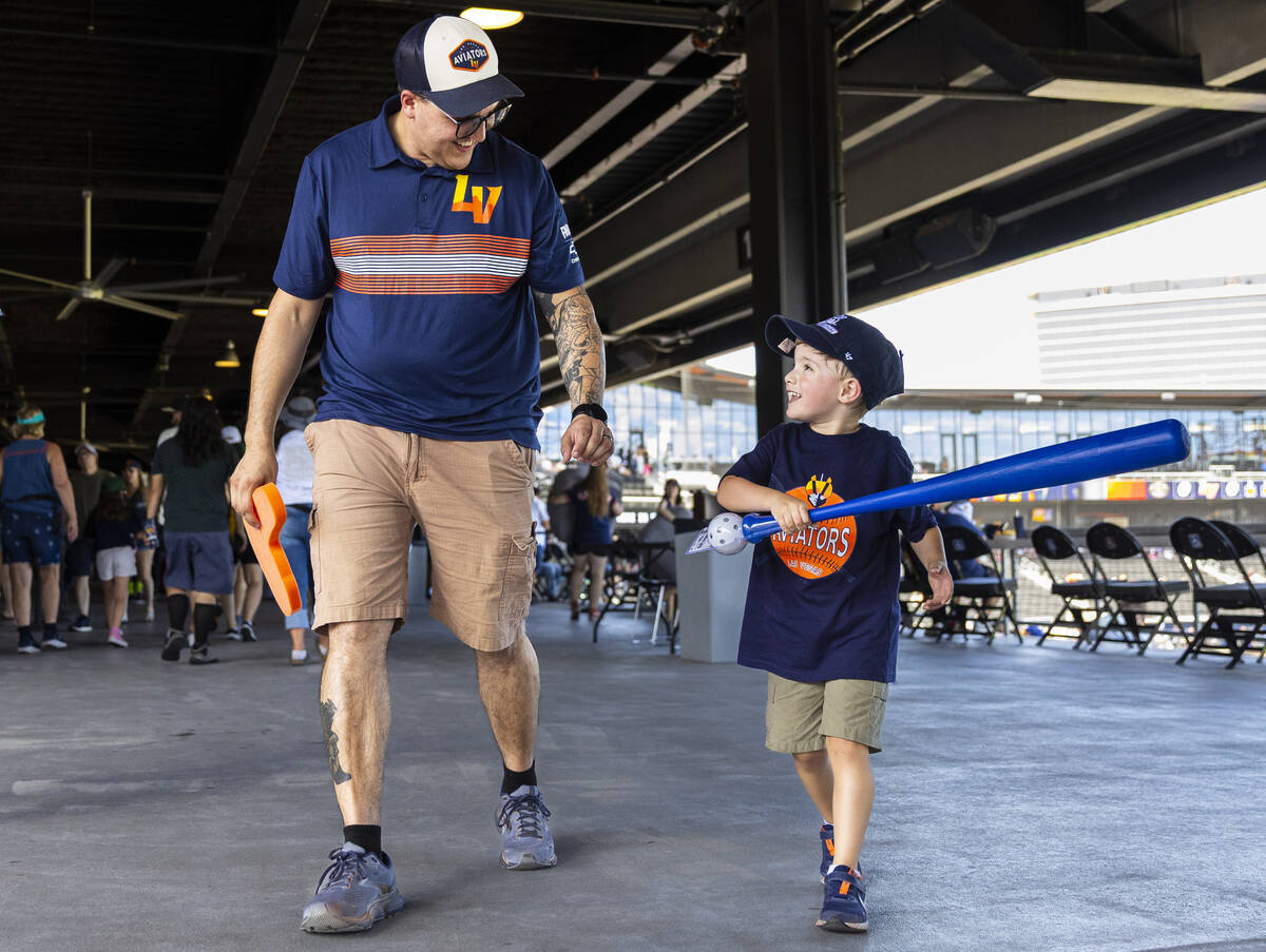 Ethan Shacklock, left, walks the concourse with his son Levi Shacklock, 4, during Father&#x2019 ...