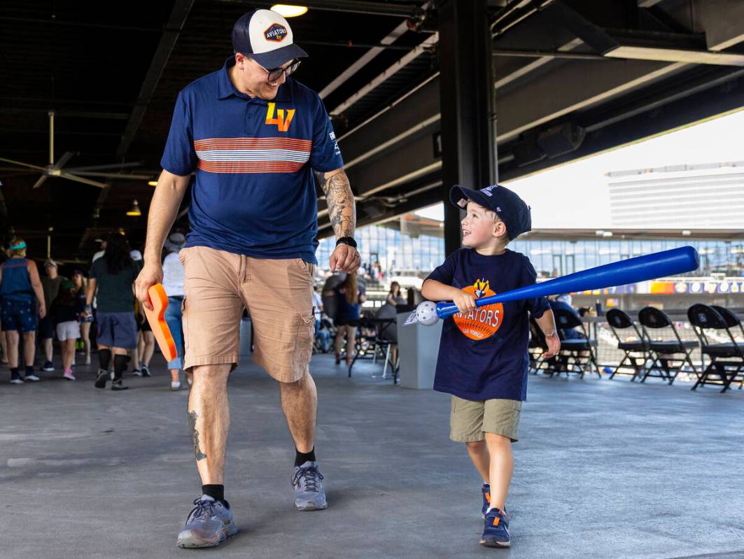Ethan Shacklock, left, walks the concourse with his son Levi Shacklock, 4, during Father&#x2019 ...