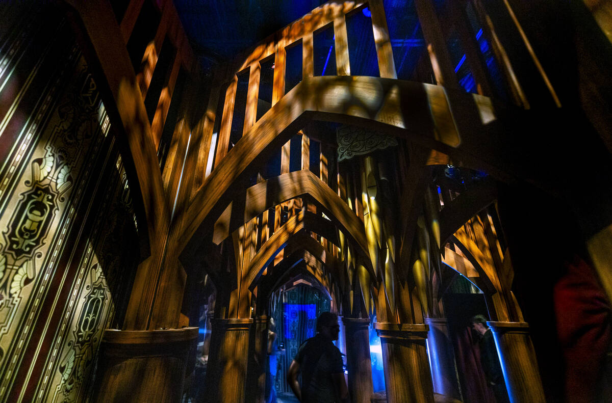Visitors pass beneath an ornate passageway within the Universal Monsters house during a first l ...