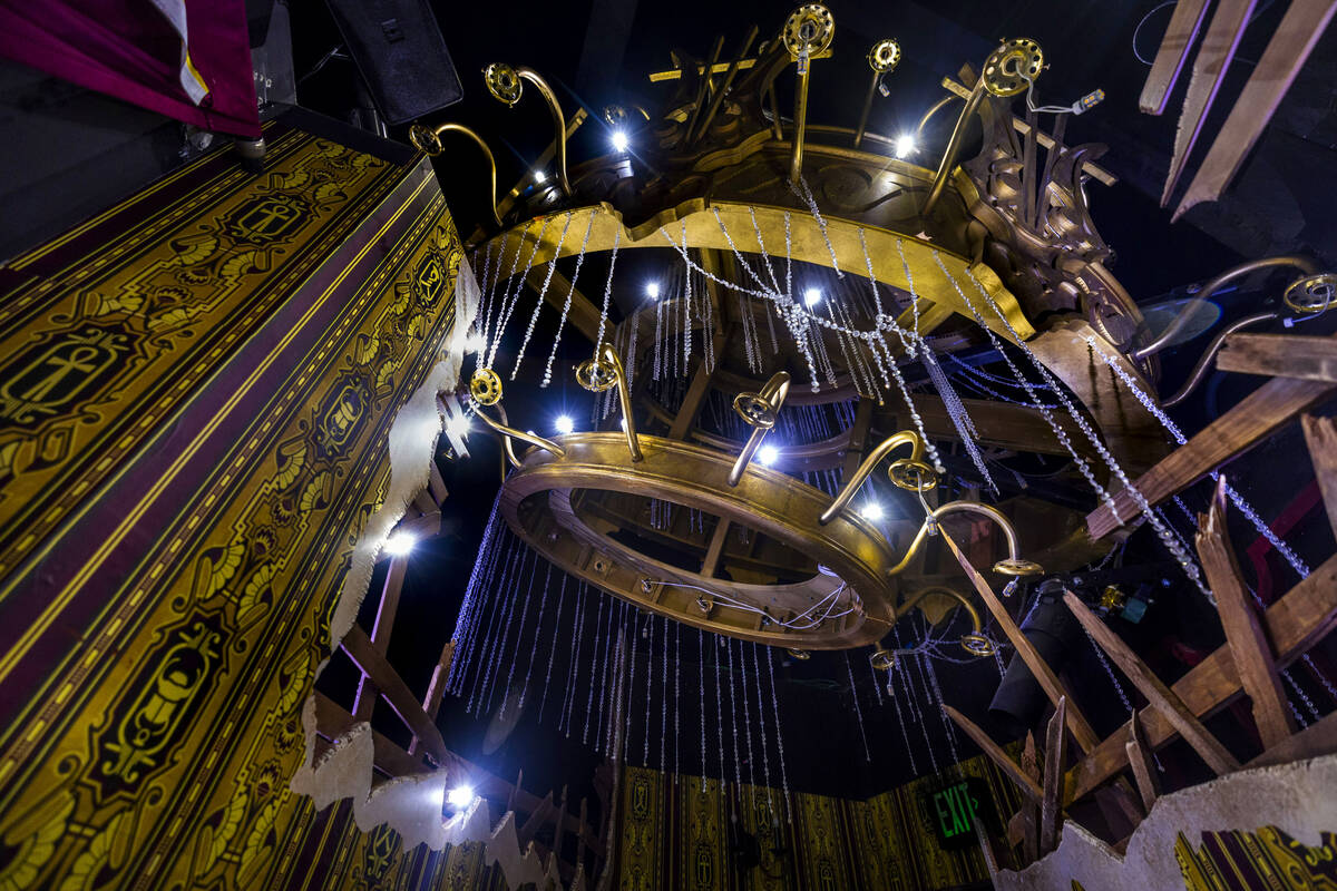 Visitors pass beneath an ornate but damaged chandelier within the Universal Monsters house duri ...