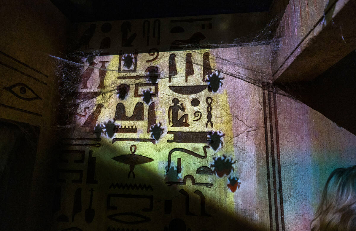 Spiders appear to be crawling up a wall within the Universal Monsters house during a first look ...