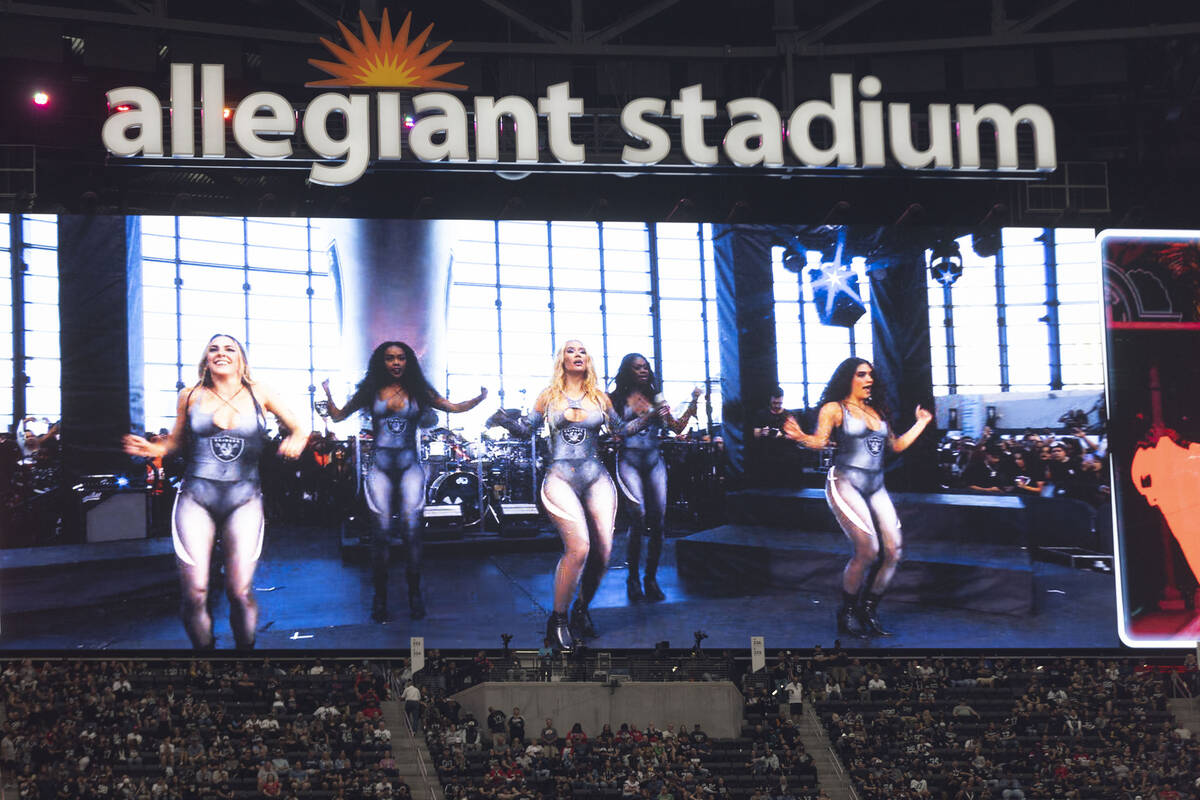 Singer Iggy Azalea, center, performs during halftime of an NFL game between the Raiders and the ...