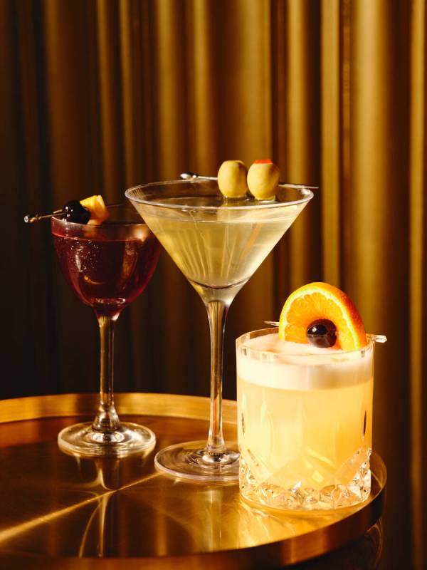 A manhattan, a dirty martini and a whiskey sour from Clique Bar & Lounge in The Cosmopolitan o ...