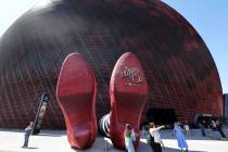 People check out the Wicked Witch of the East legs and ruby slippers installation promoting &qu ...