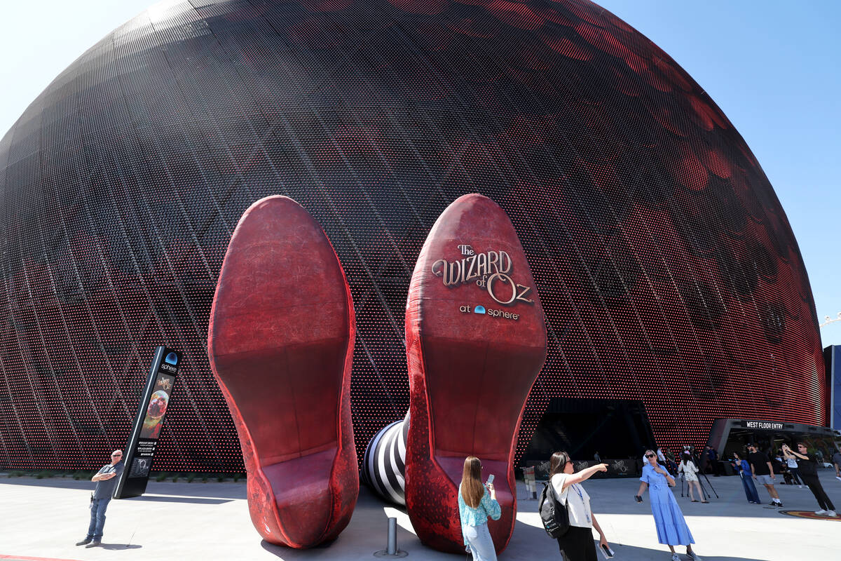 People check out the Wicked Witch of the East legs and ruby slippers installation promoting &qu ...