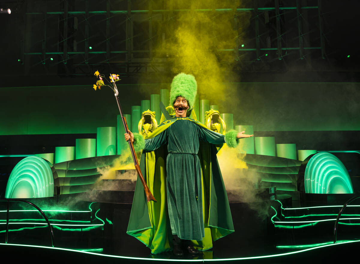 A performer addresses the crowd during a rehearsal of the atrium pre-show as part of "The ...