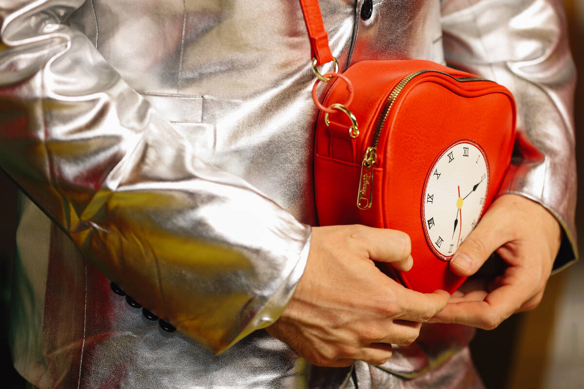 An influencer poses with a heart shaped bag on a red carpet at the world premiere of “Wi ...