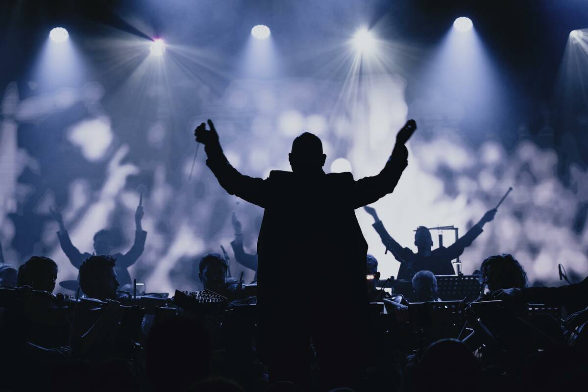 Symphony of Unity conductor Kevin Houben leads about 50 musicians, who infuse electronic tracks ...