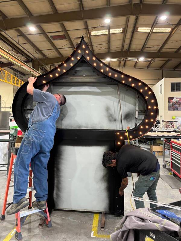 Sign fabricator Warren Donlon, left, and project manager Kevin Cooper are shown restoring the o ...