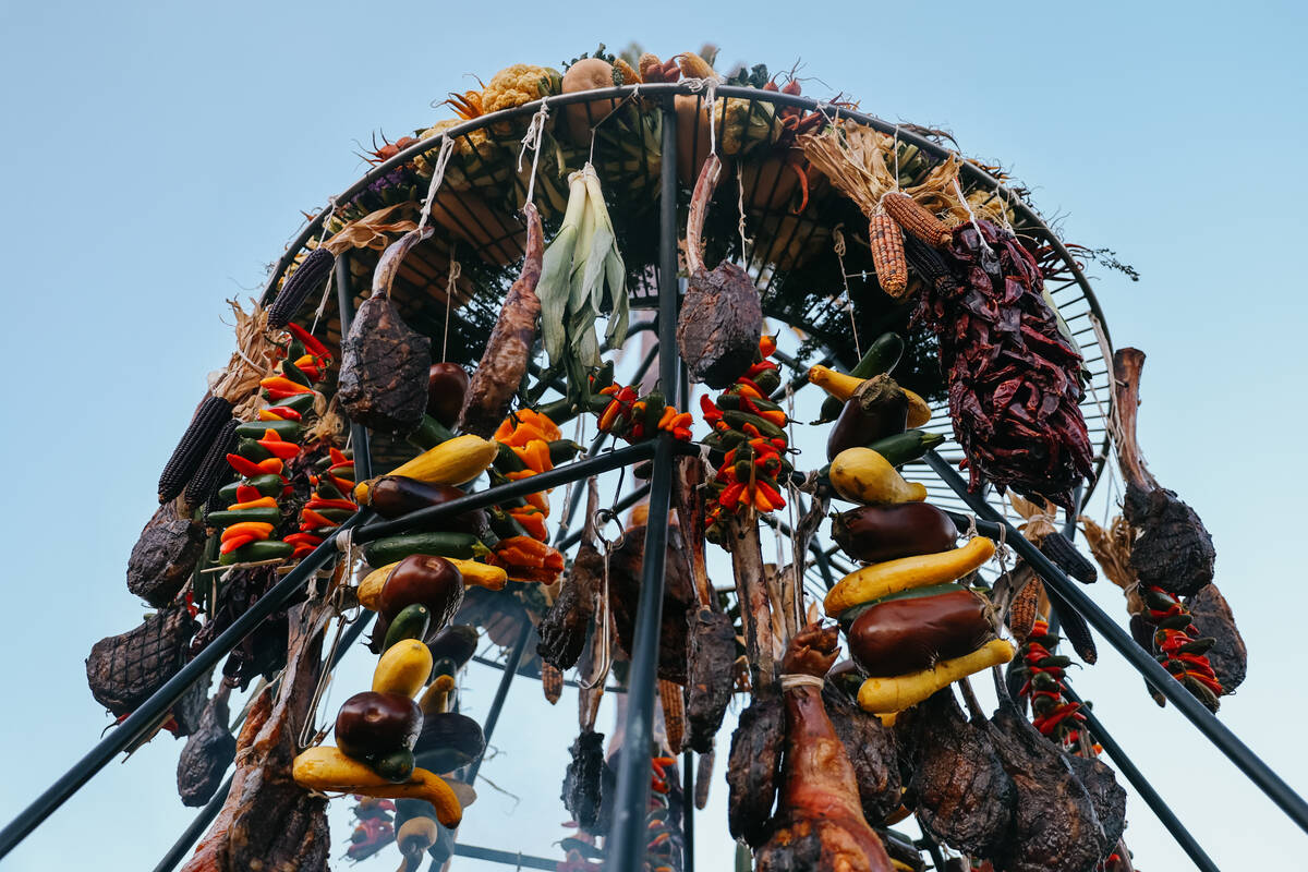A large tower of cooked meat and vegetables hangs at Four Sixes Ranch Steakhouse’s booth ...