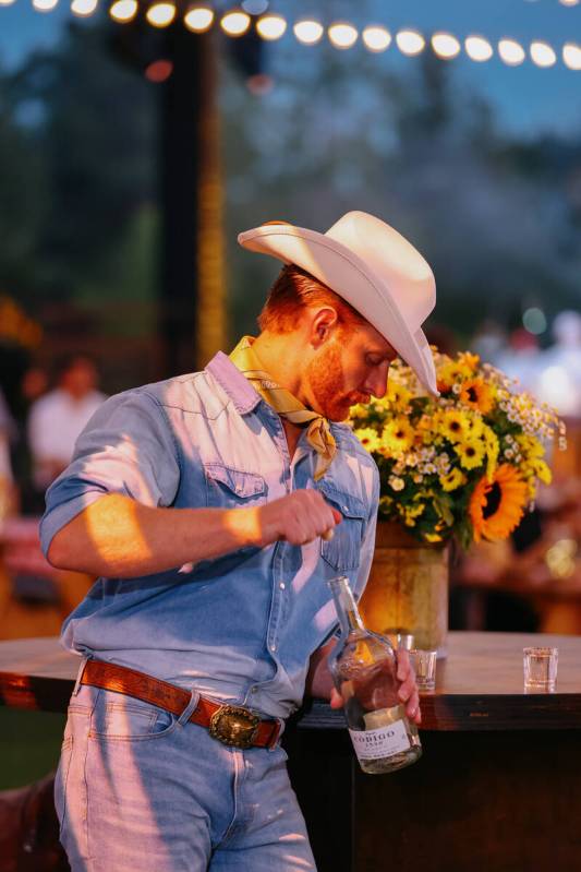 Wyatt Hopkins uncorks a bottle of tequila during Revelry’s The Feast on Saturday, Sept. ...