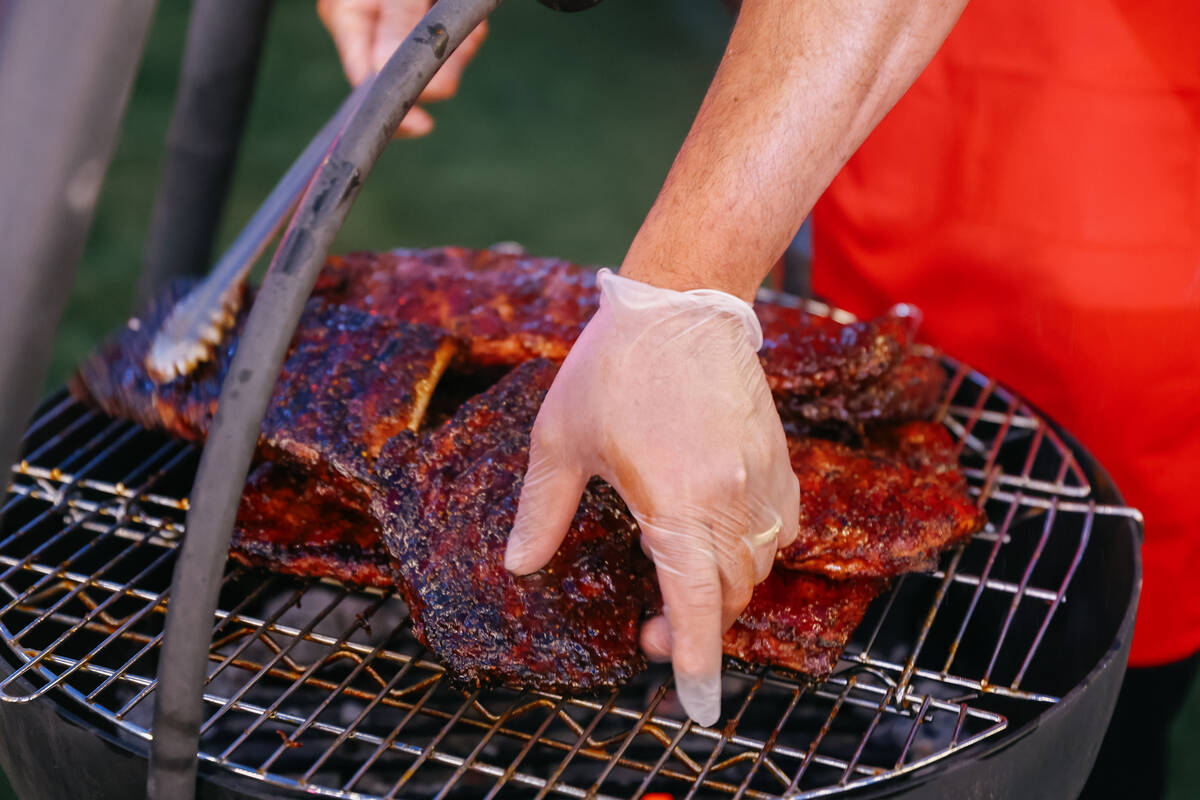 St. Louis smoked and grilled pork ribs from Slab, a restaurant in Los Angeles, cook at a Four S ...