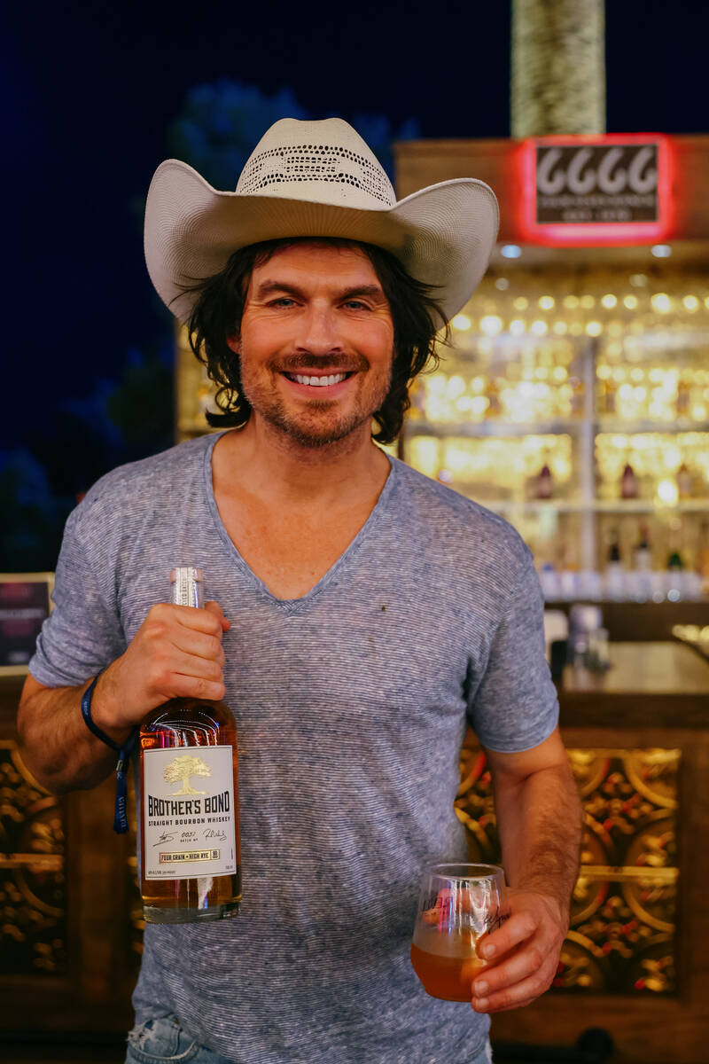 Actor Ian Somerhalder poses for a portrait with a bottle of his bourbon whiskey during Revelry& ...