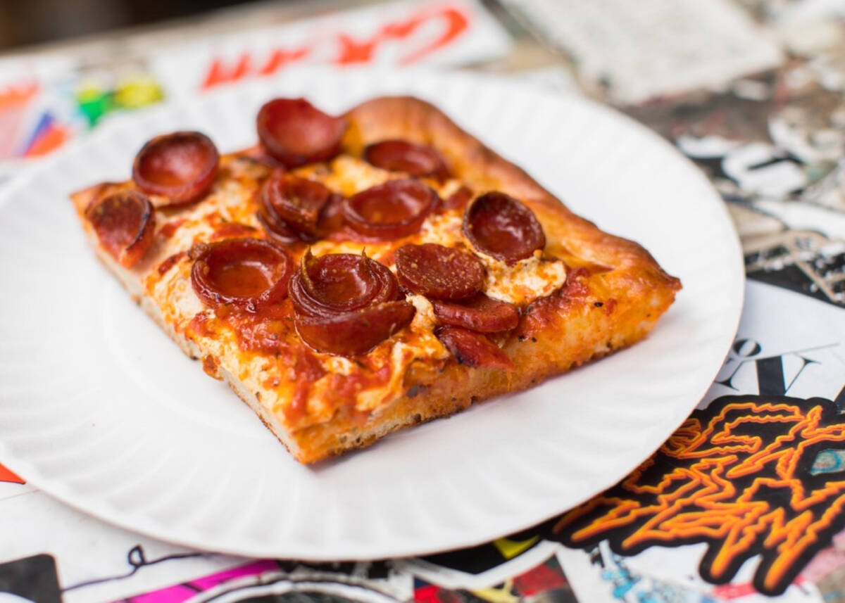 A slice of signature Spicy Spring pizza, a Sicilian pie, from Prince St. Pizza of New York City ...