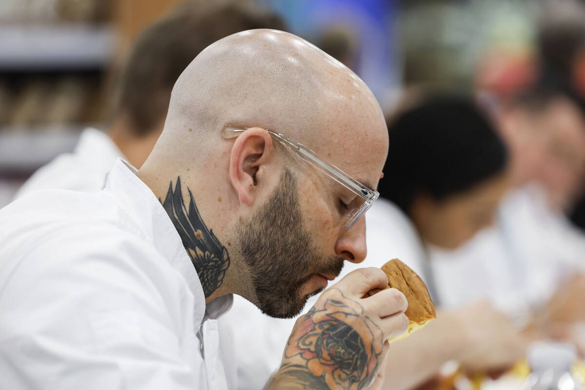 Judge and pastry chef Marco Lusso smells a sample of panettone during the Panettone World Cup a ...
