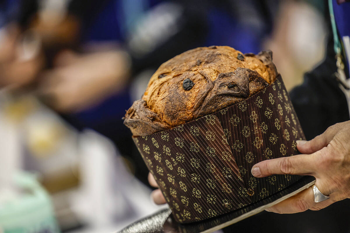 Volunteers hold samples of panettone before they are prepared for judging during the Panettone ...