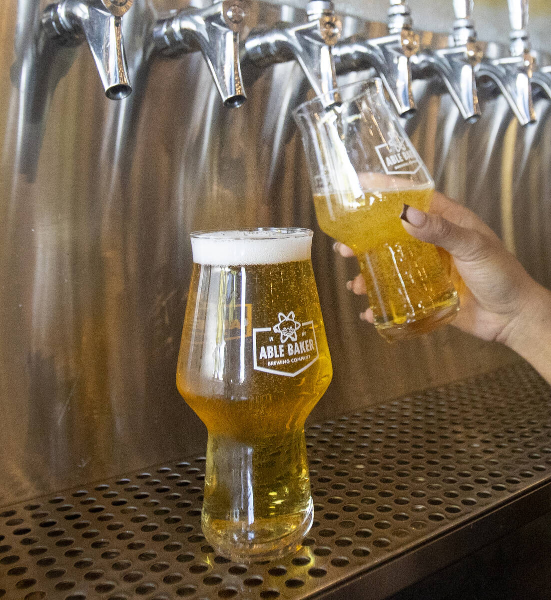 Irish Domingo pours glasses of Atomic Duck at Able Baker Brewery, Monday, Sept. 30, 2024, in La ...