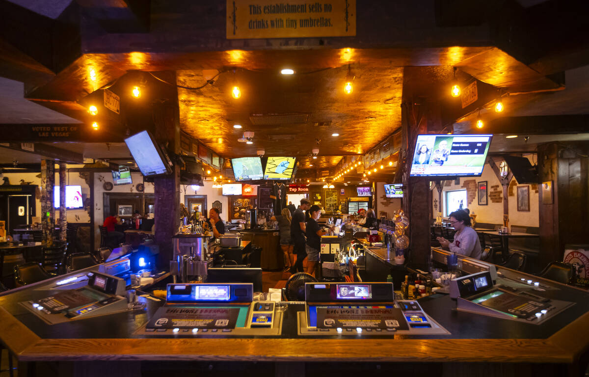 Bartenders assist customers at Big Dog’s Draft House, at 4543 N. Rancho Drive, on Thursday, S ...