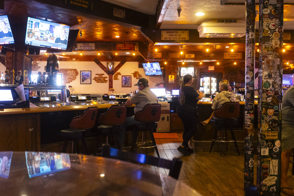 Bartenders assist customers at Big Dog’s Draft House, at 4543 N. Rancho Drive, on Thursday, S ...