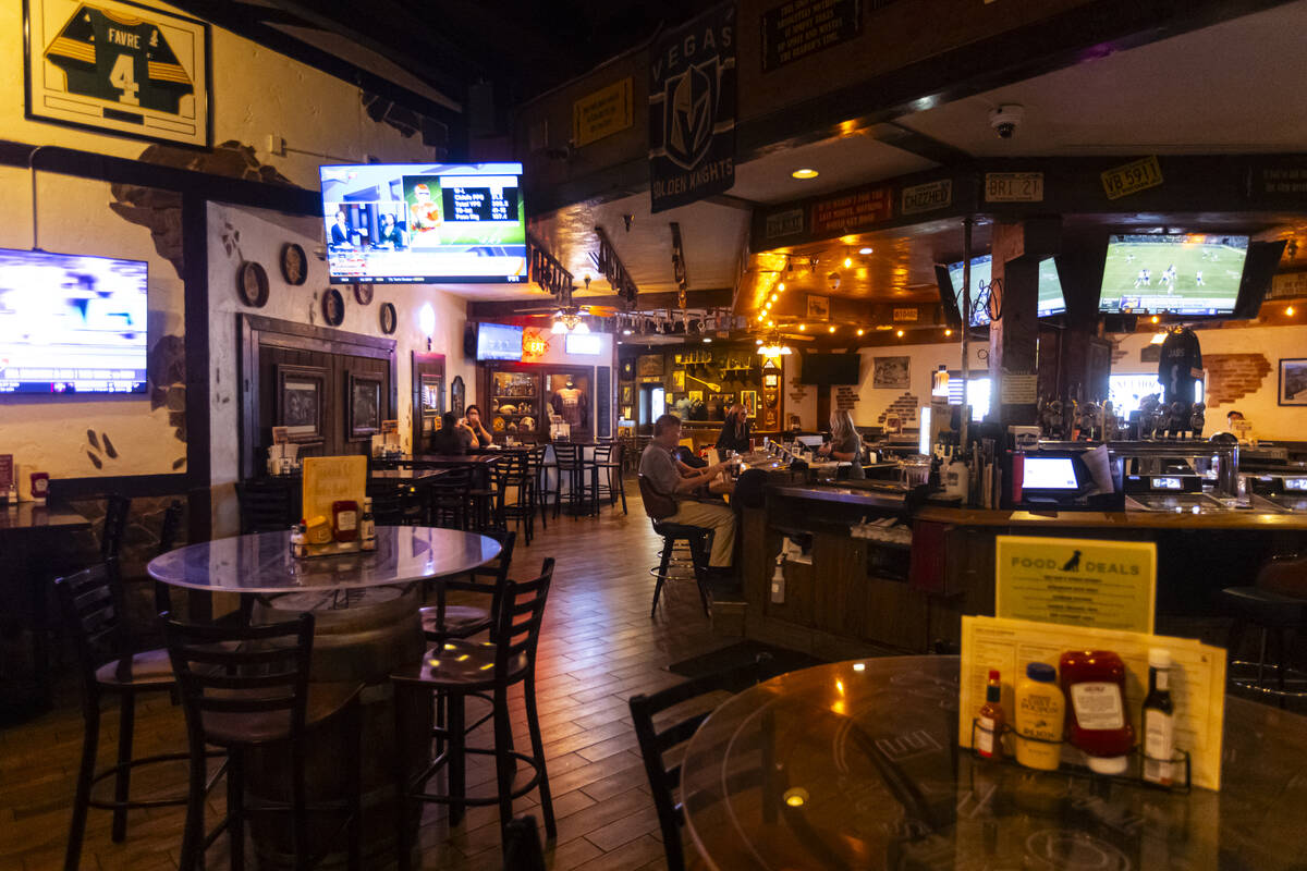 People sit at the bar at Big Dog’s Draft House, at 4543 N. Rancho Drive, on Thursday, Sept. 1 ...