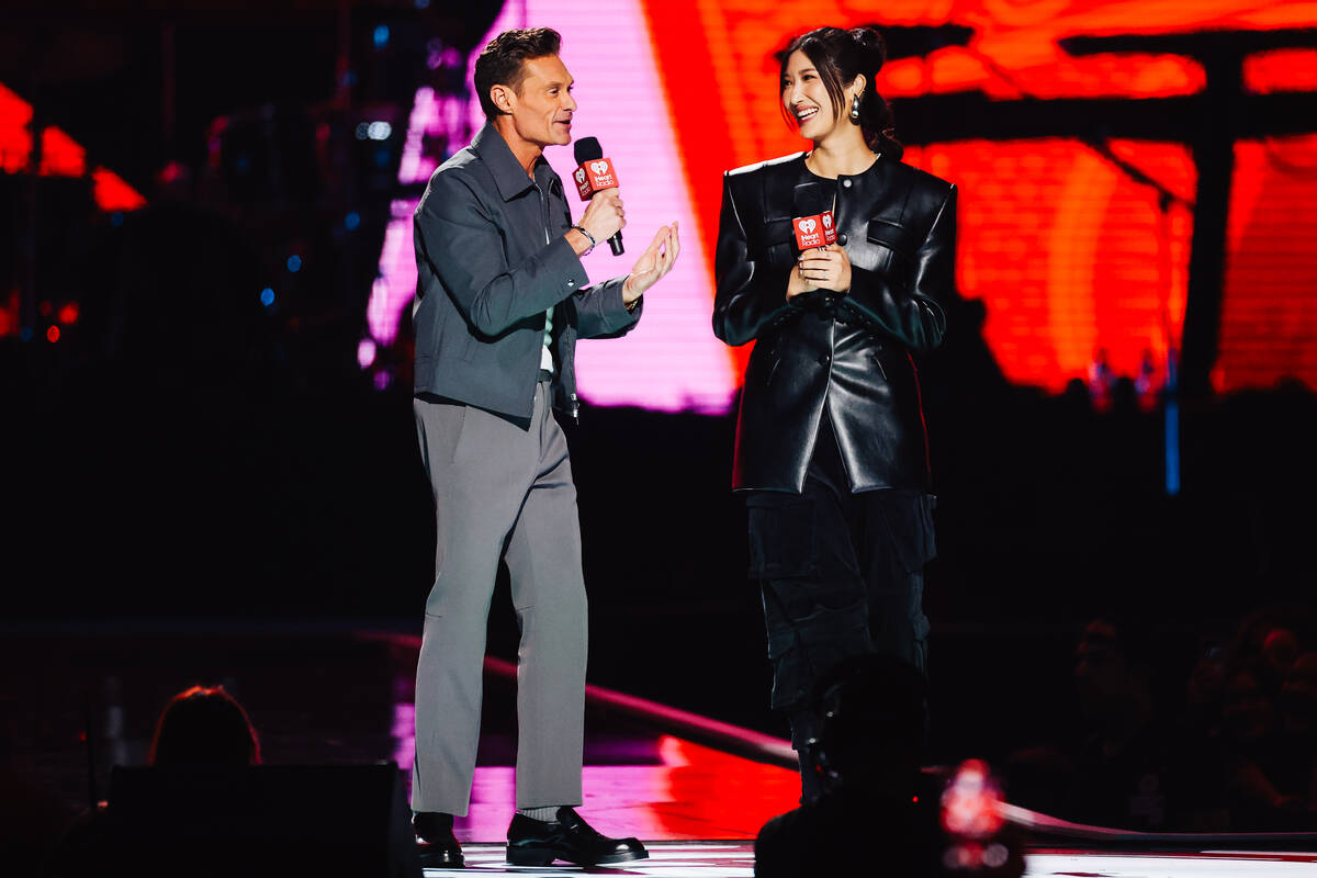 Ryan Seacrest, left, and Ejae presents during night one of the iHeartRadio Music Festival at T- ...
