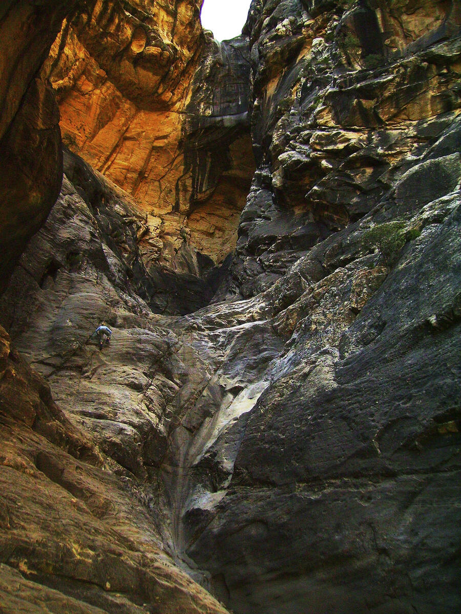 A hiker climbs the steep walls of Ice Box Canyon in Red Rock Canyon National Conservation Area. ...