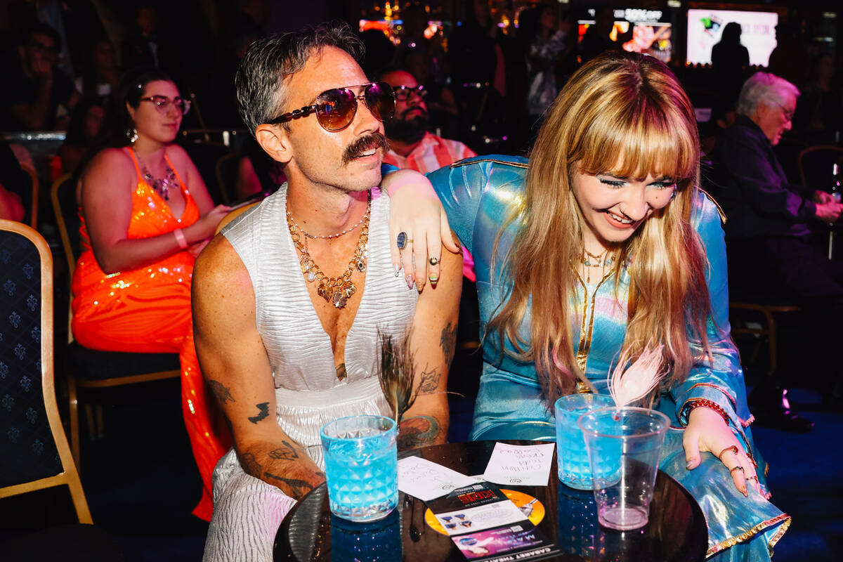 Rich Porter, left, and Caitlen Todd listen to the album during a listening party for Taylor Swi ...