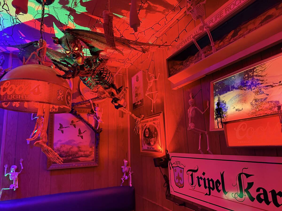 With red lighting and thousands of props, The Silver Stamp bar in downtown Las Vegas transforms ...
