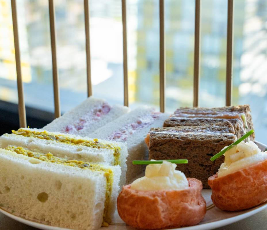 Clockwise from left: curried chicken, strawberry cream, and smoked salmon sandwiches, and brie ...