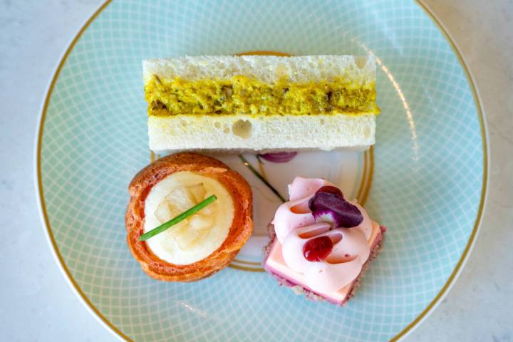 A curried chicken sandwich sits above brie and pear gougère, left, and a spice cake during Pea ...