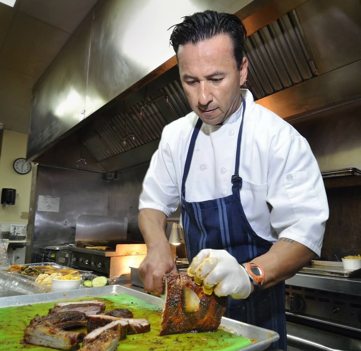 Chef John Bell slices ribs at Bell’s BBQ on South Eastern Avenue in Henderson in this Las Veg ...