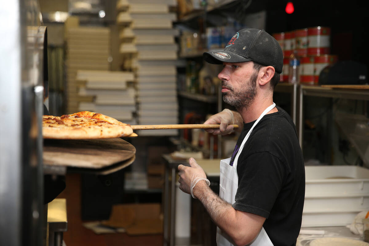 Will Stander prepares a pizza at Evel Pie in Las Vegas, Tuesday, July 30, 2019. (Erik Verduzco ...