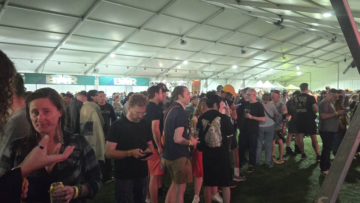 Attendees take shelter as a storm rolls through downtown Las Vegas, pausing the outdoor Best Fr ...