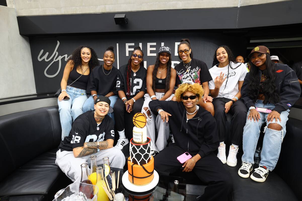 The three-time WNBA champion Las Vegas Aces are shown with a cake presented by Wynn Nightlife a ...