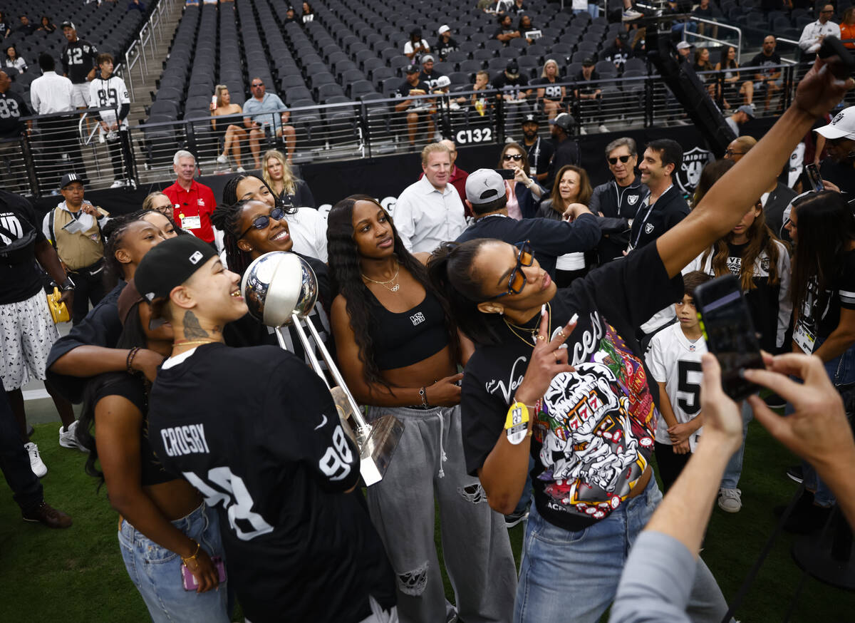 Aces’ A’ja Wilson, right, takes a selfie with teammates before the start of an NF ...
