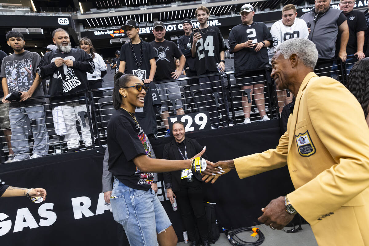 Former Raiders cornerback Mike Haynes, right, congratulates Aces' A'ja Wilson as the ...