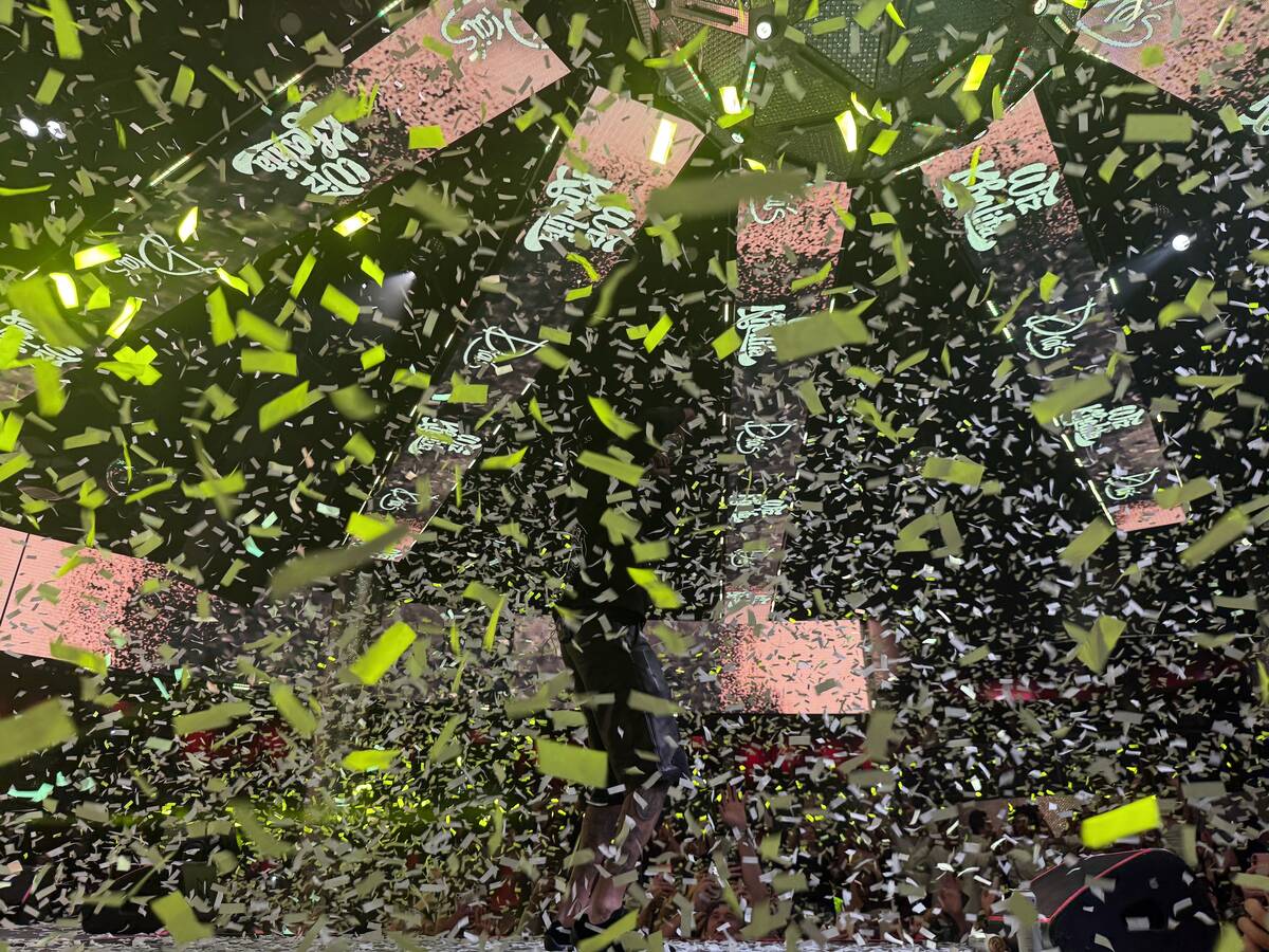 Rap star Wiz Khalifa is shown in a blizzard of confetti at three-time WNBA champion Las Vegas A ...