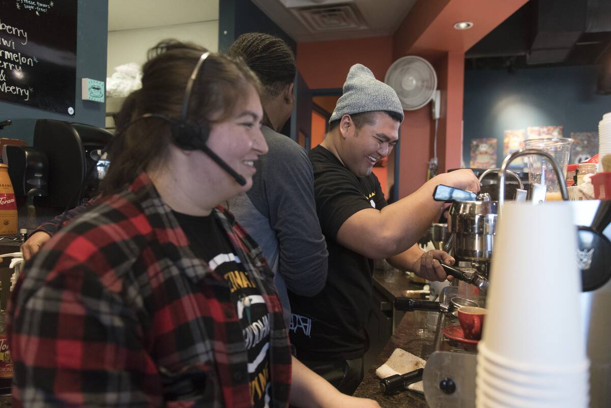 From left, Destiny Gray, Jay White and J.R. Rose prepare orders at Grouchy John's Coffee, 8520 ...