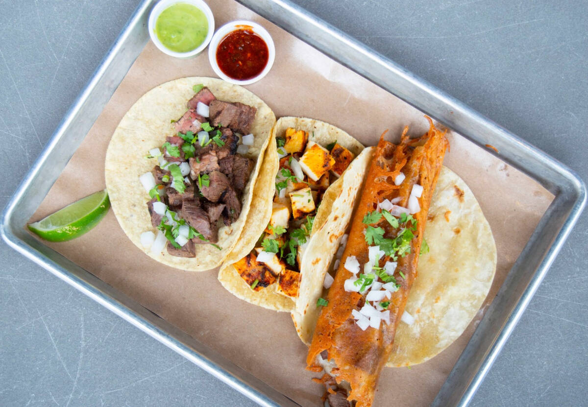 Tacos, left and center, and a La Costra taco with a griddled cheese shell from Chilangos, the D ...