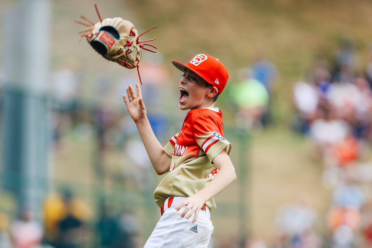 Summerlin South pitcher Luke D’Ambrosio throws his mitt up in celebration after winning a Lit ...
