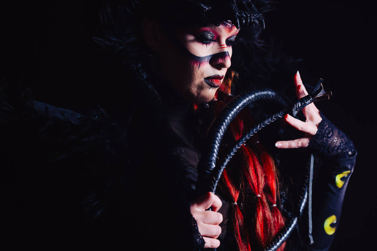 Katarina Jinx plays with her whip during a portrait session before participating in a WOW Wrest ...