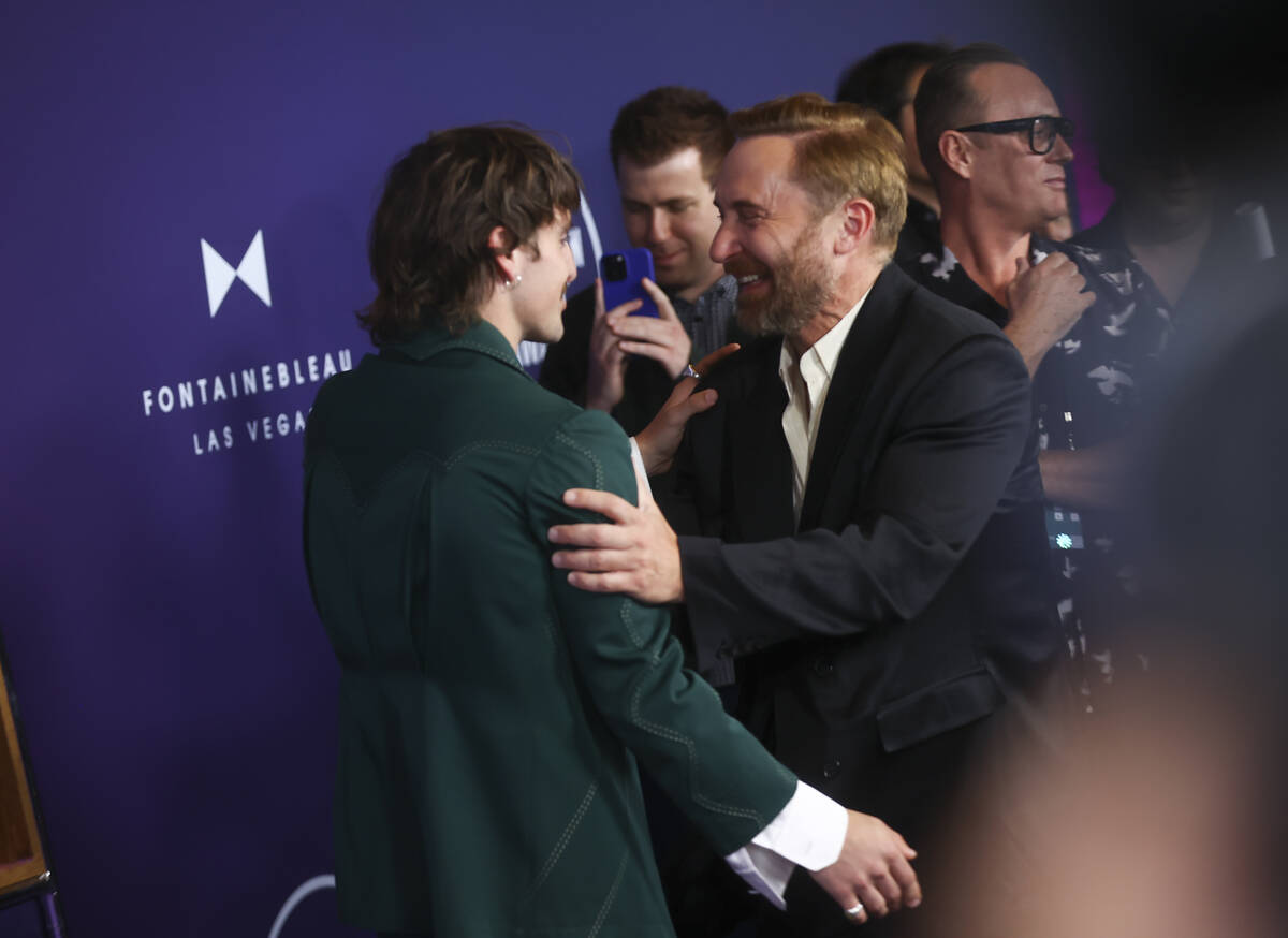 David Guetta, right, talks with Benson Boone on the red carpet for the American Music Awards at ...