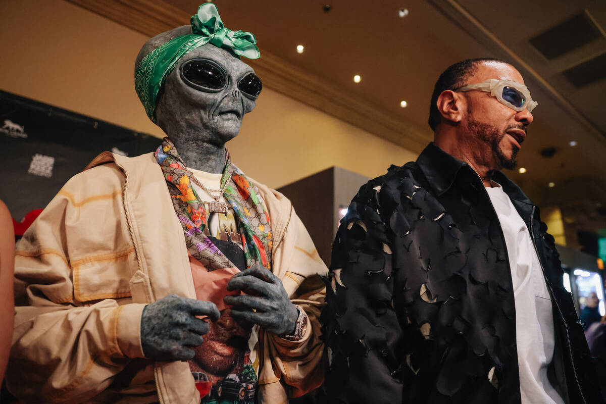 SpaceGodDaThug, left, walks a red carpet with Timbaland for the Jabbawockeez' return to th ...