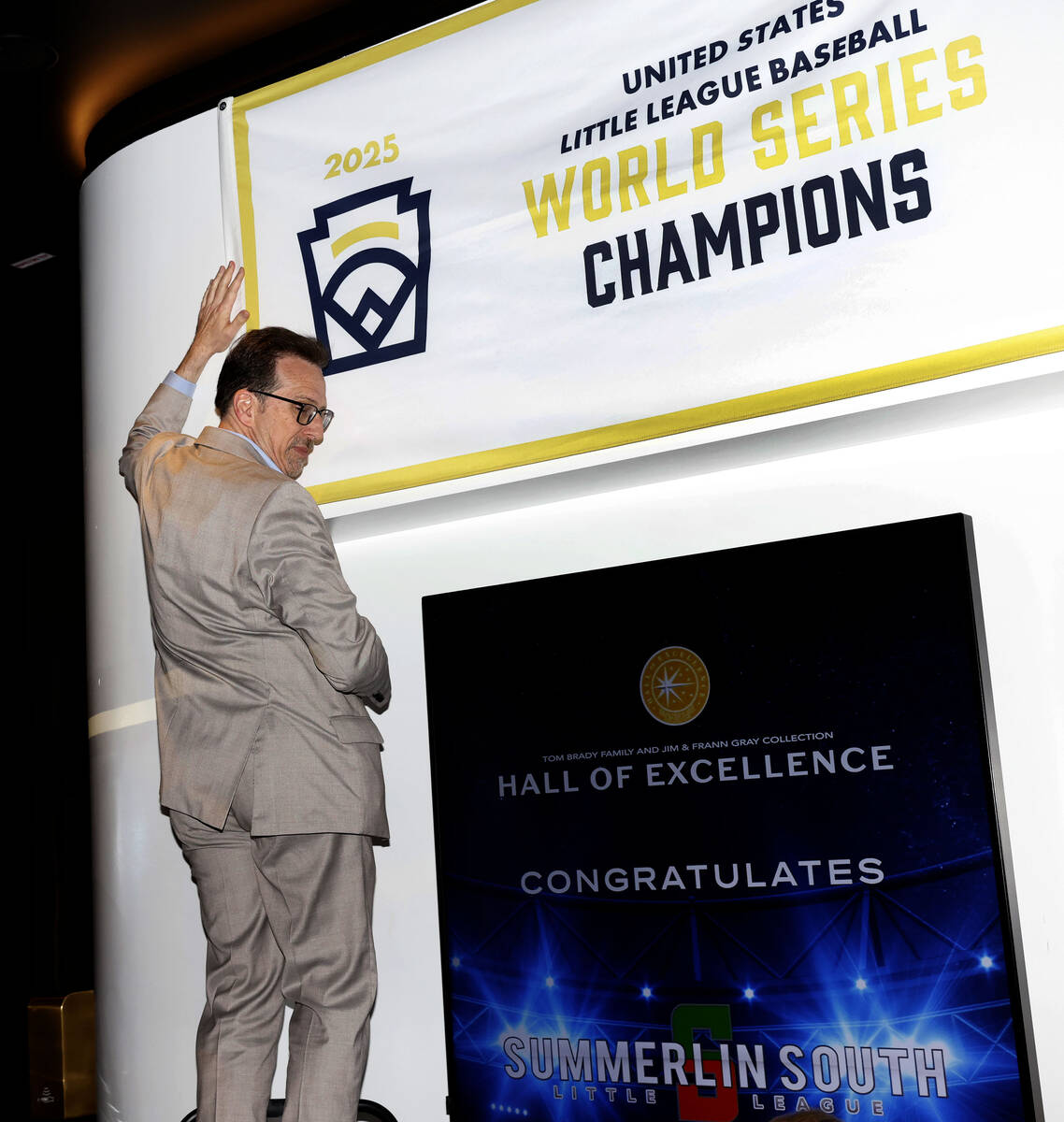 Howard Deneroff, director of the Hall of Excellence at Fontainebleau Las Vegas, unveils a banne ...