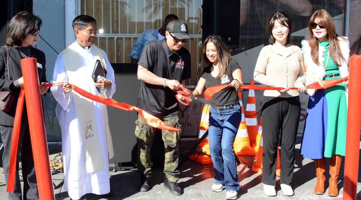 The DJ Museum owner Sam Maxion, center, cuts the ribbon at the new attraction at 3507 South Mar ...
