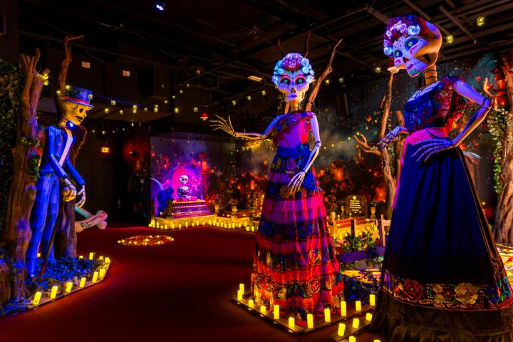 Giant figures in a cemetery room within The Colors of Mexico gallery and restaurant hosting a s ...