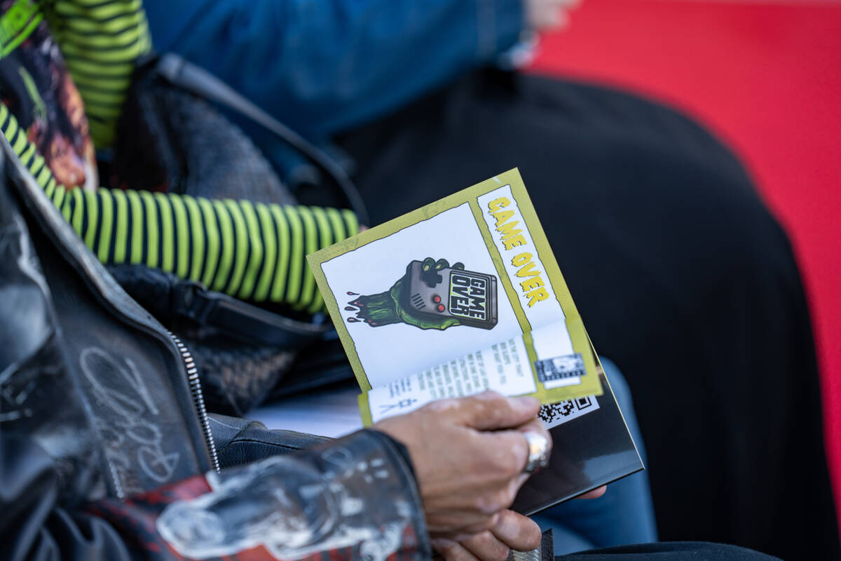Guests flip through information books during an event announcing HallowScreamCon and HallowScre ...